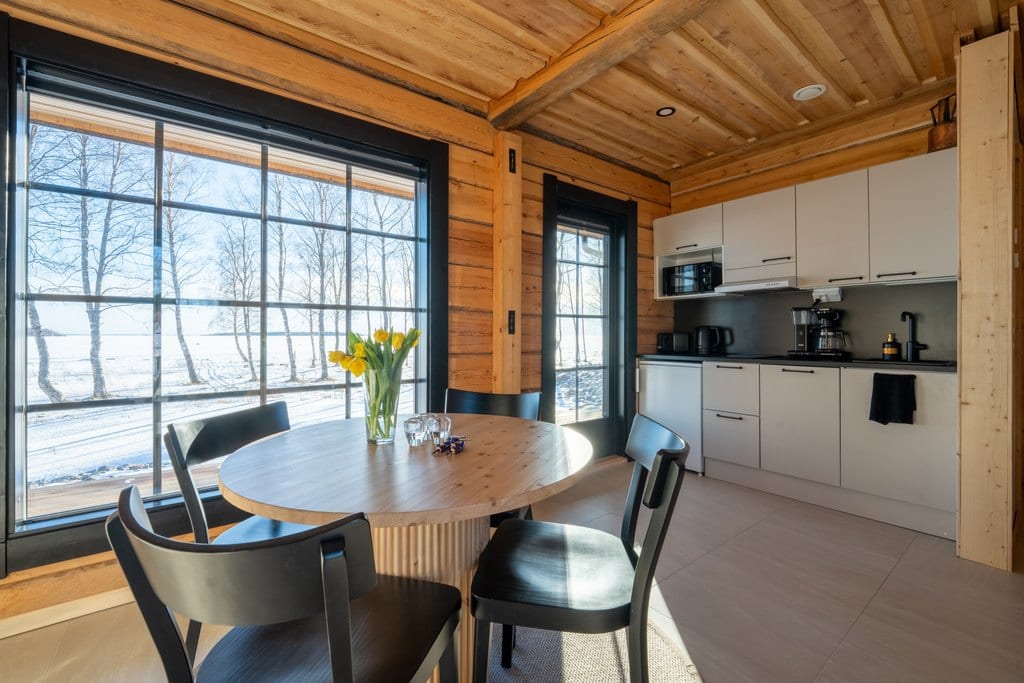 Kitchen and round dining table by a snowy view