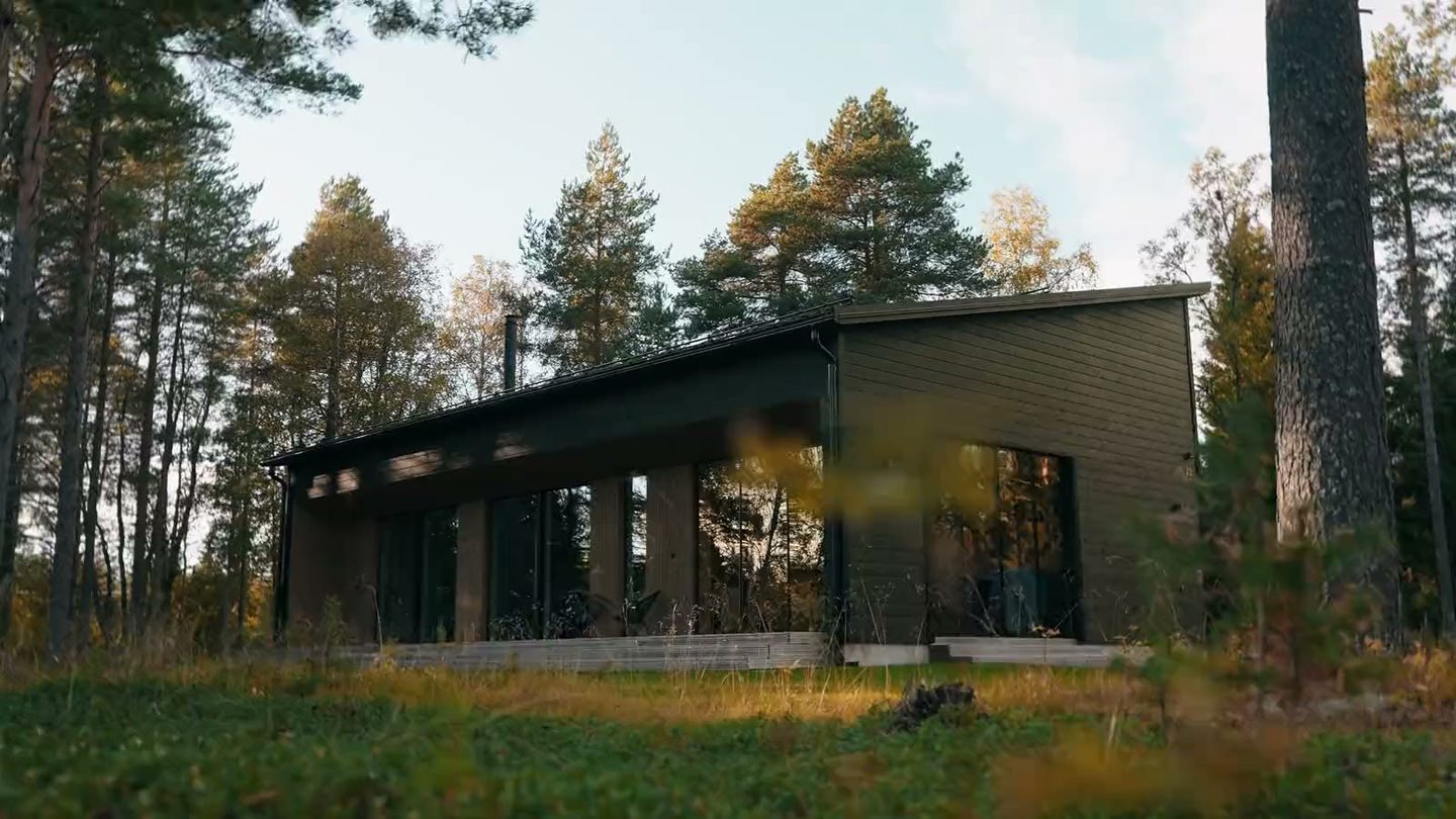 Havu, a dark two-storey cottage among pine trees