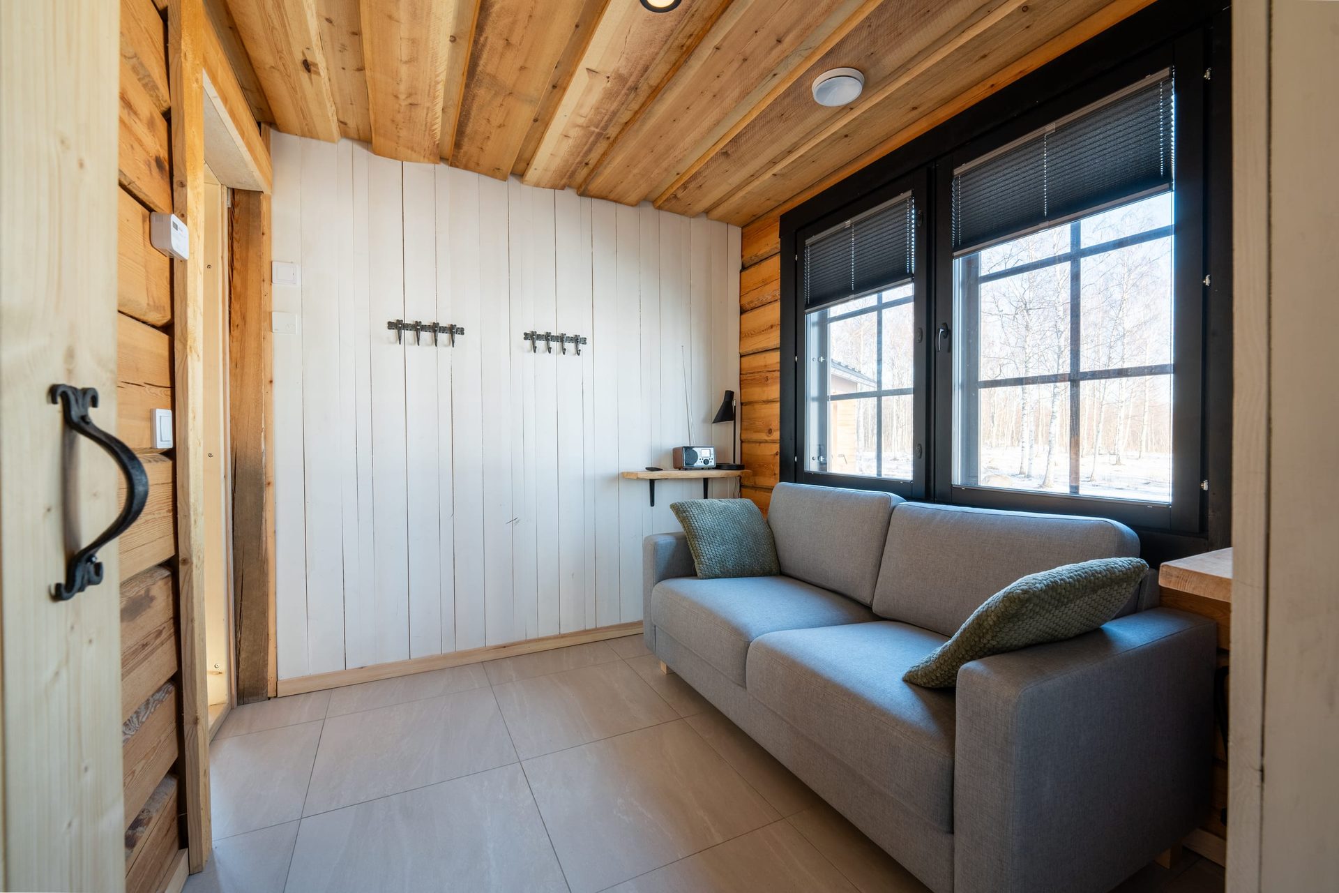 Usva's gray sofa in front of the windows
