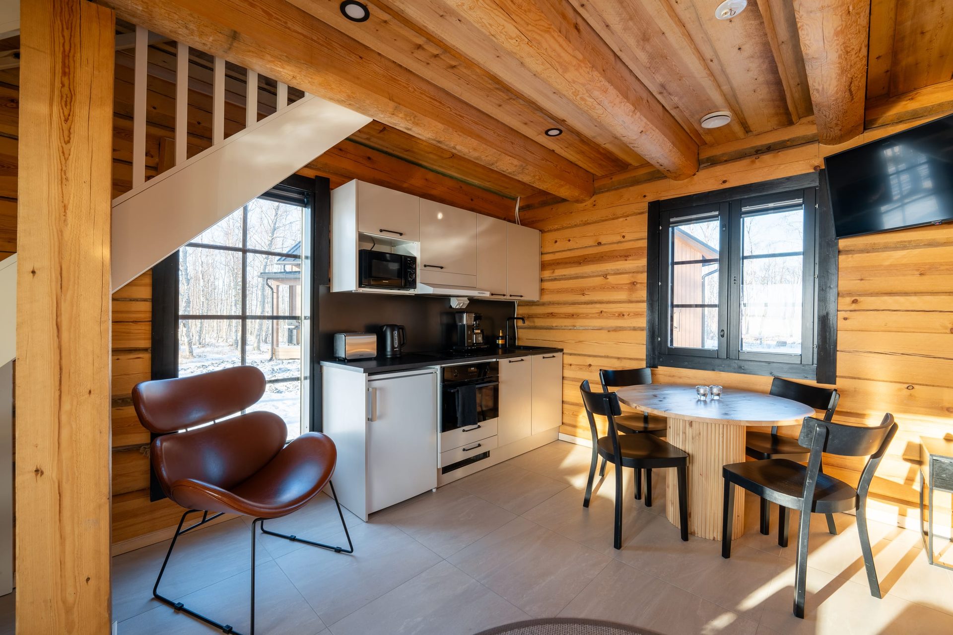 Usva kitchen, dining table and leather armchair under the stairs