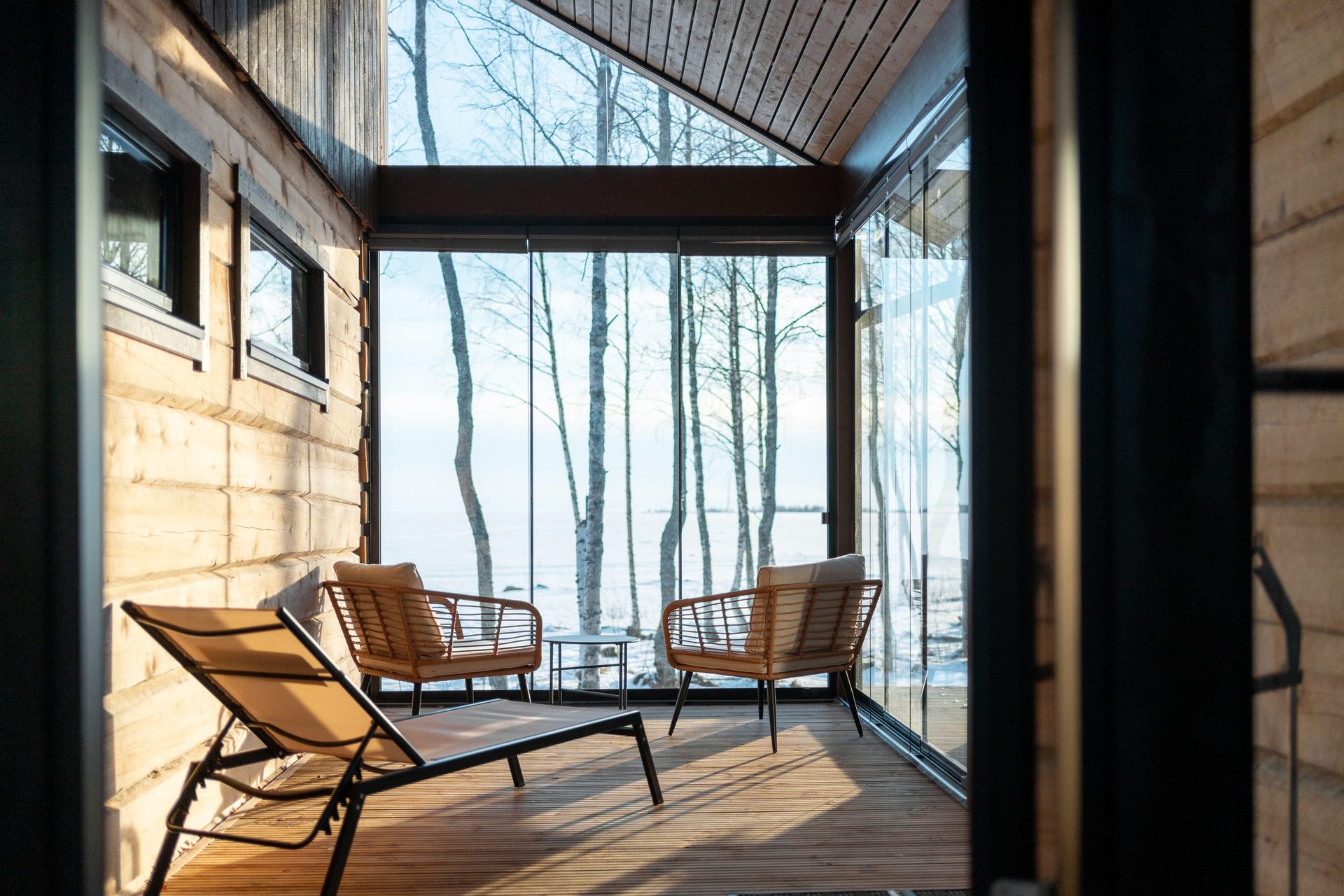 Usva glazed terrace with chairs and a view of snowy ice