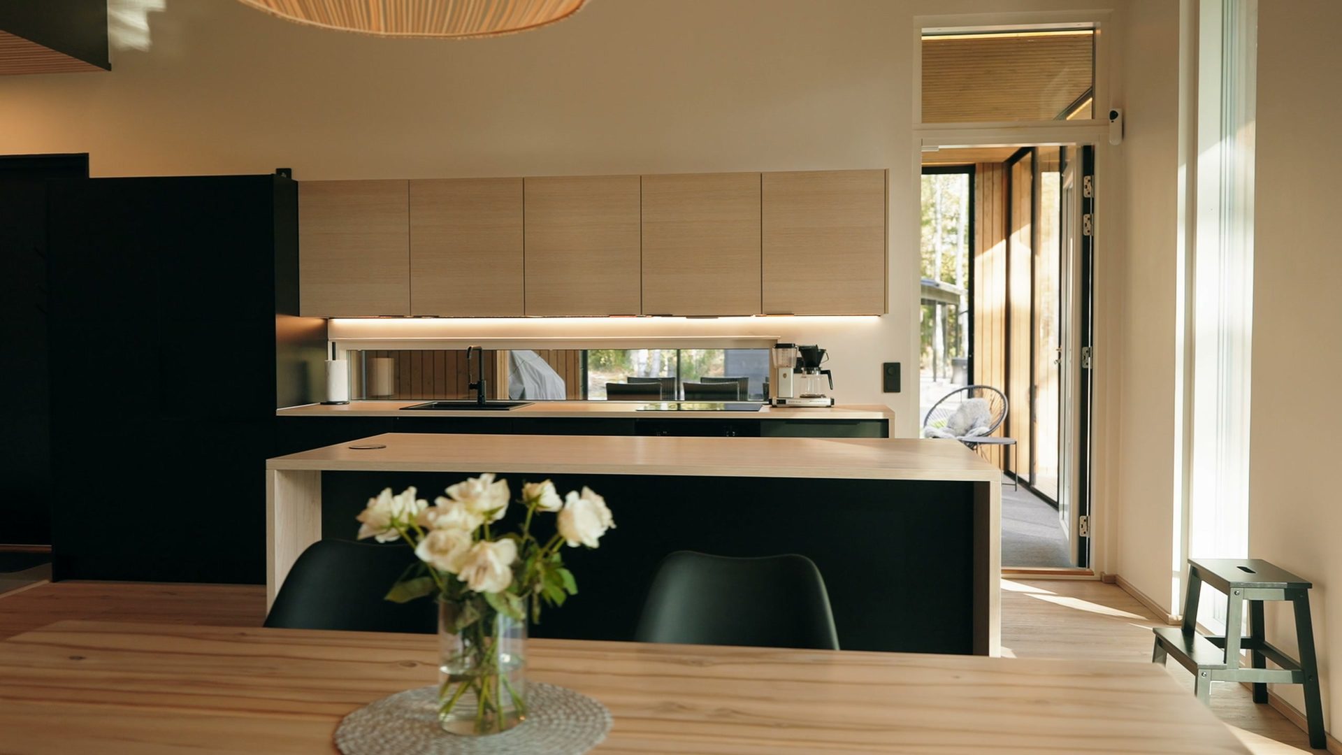 Kitchen with an island and a dining table with flowers