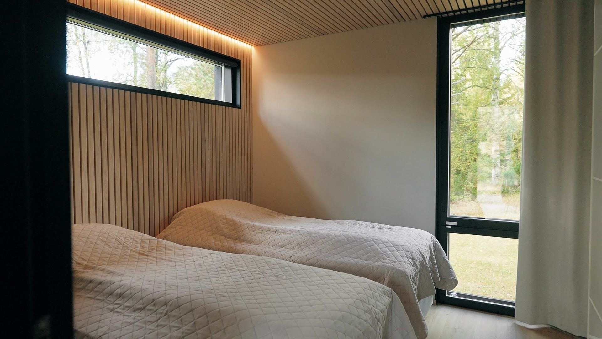 Bedroom with two beds and a window to the yard
