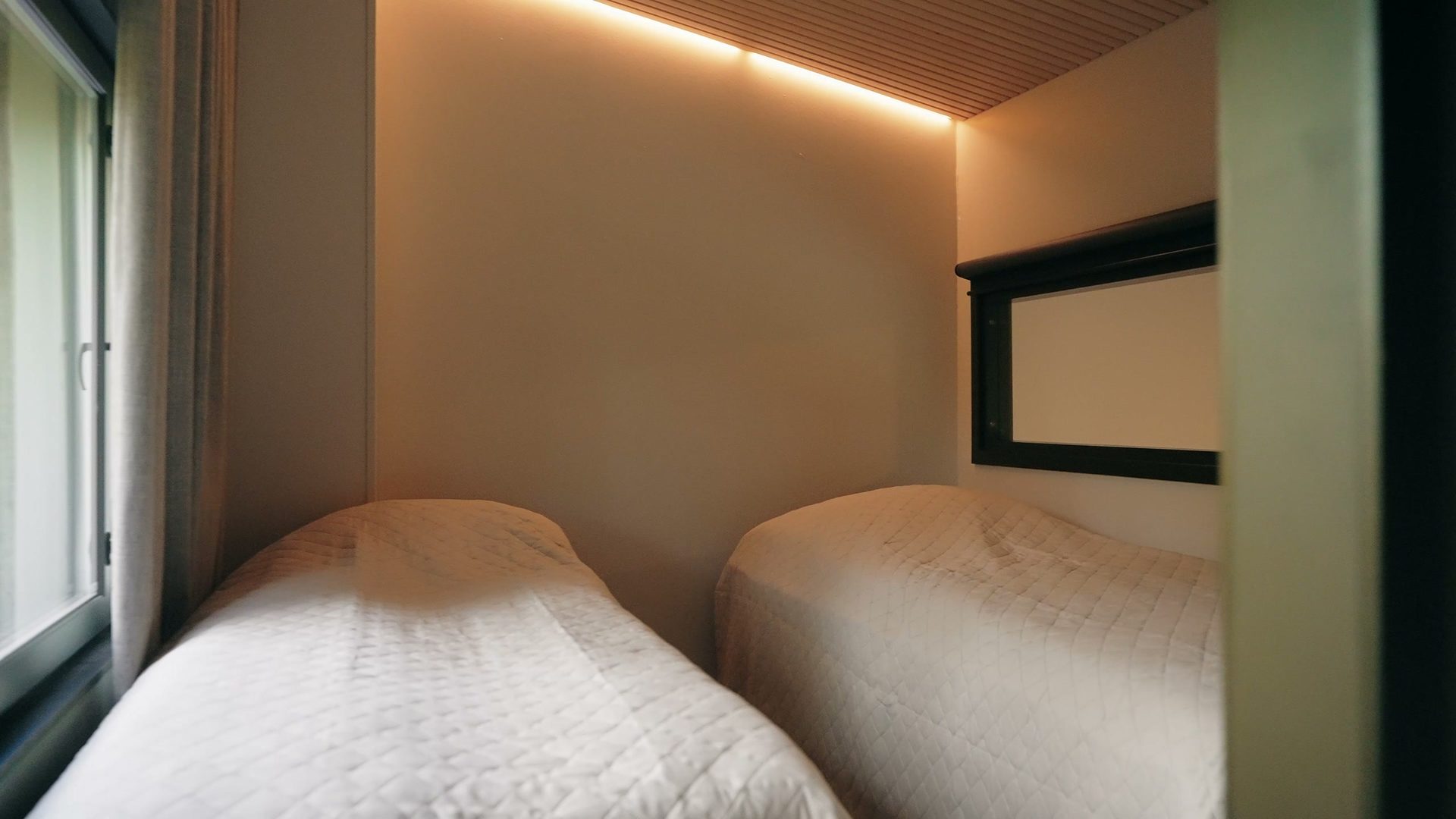 Bedroom with two beds and a wooden ceiling