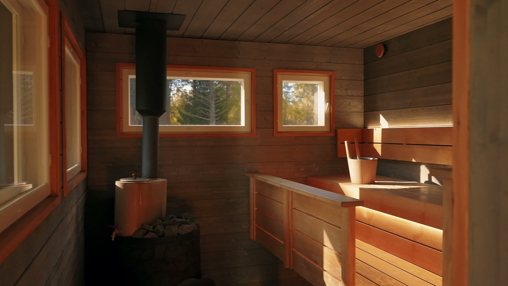 Outdoor sauna with a wood-burning stove and benches