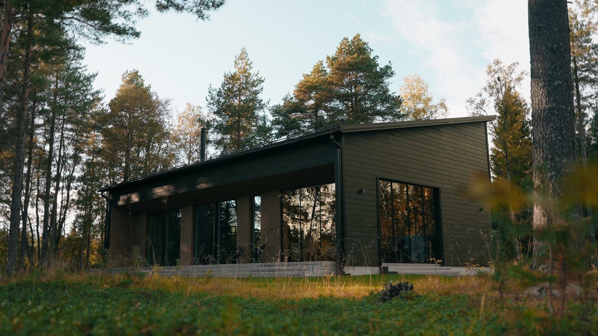 Havu, a dark two-storey cottage among pine trees