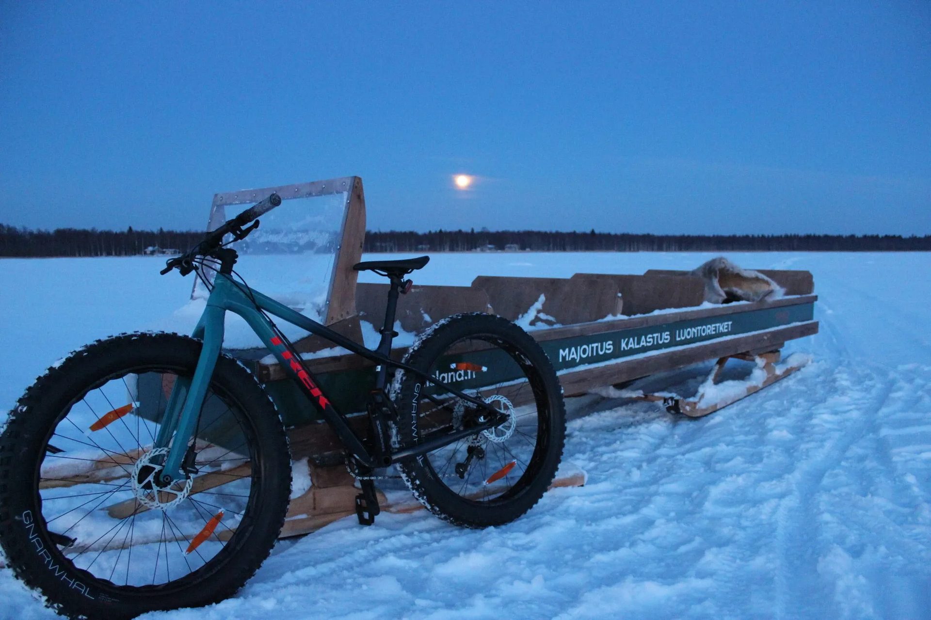 A fatbike in front of a sleigh on the sea ice