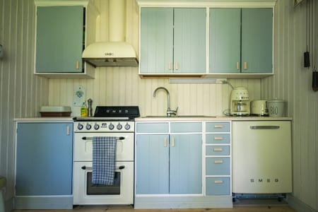 Pauhu kitchen with pale blue cabinets and cream appliances