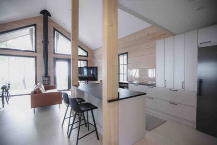Open kitchen with an island, bar stools and fireplace