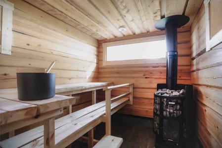 Light wooden sauna with benches and a stove
