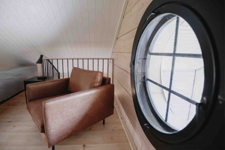 Aava loft leather armchair and round window